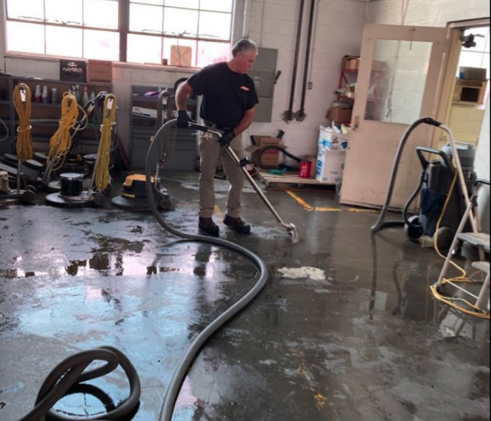 technician extracting water in garage