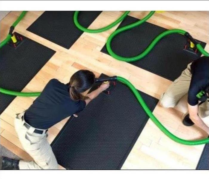 employee putting down drying mats